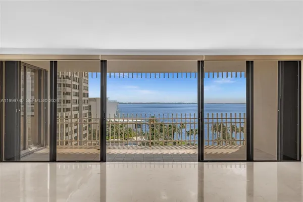 a view of a kitchen with refrigerator and a living room