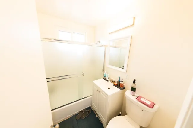 a bathroom with a sink toilet and shower