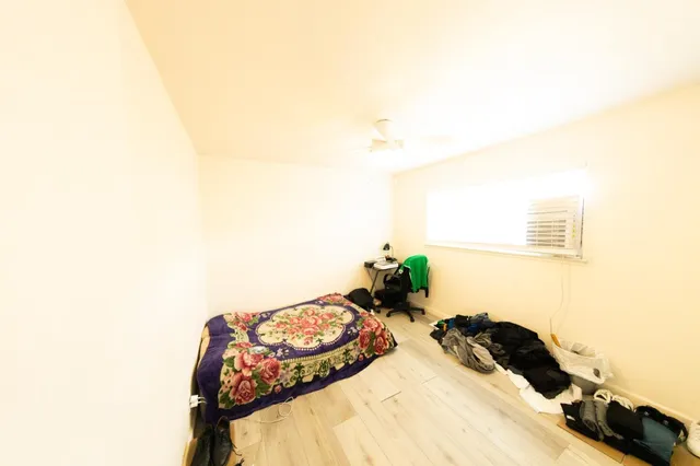 a bedroom with a bed and a lamp