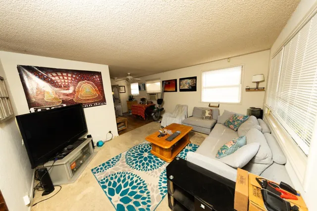 a bedroom with furniture and a flat screen tv