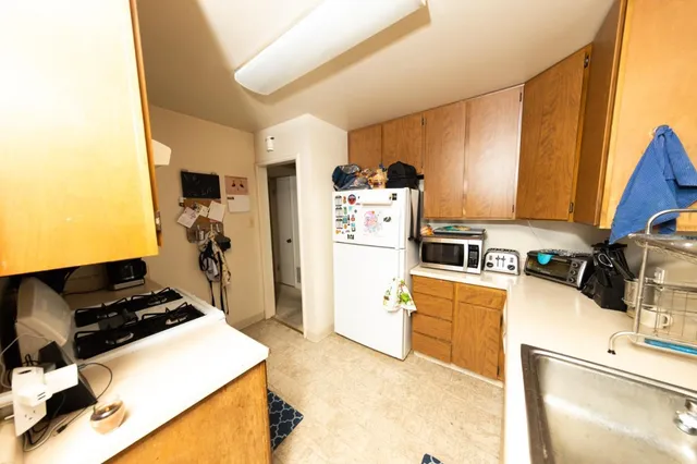 a kitchen with a refrigerator and a stove