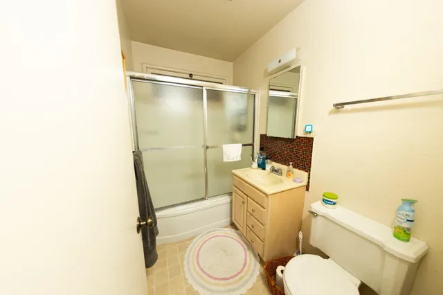 a bedroom with a bed and a flat tv screen on the wall