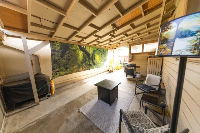 a view of a patio with a dining table and chairs