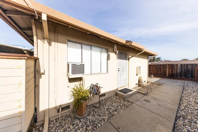 a view of a house with wooden fence