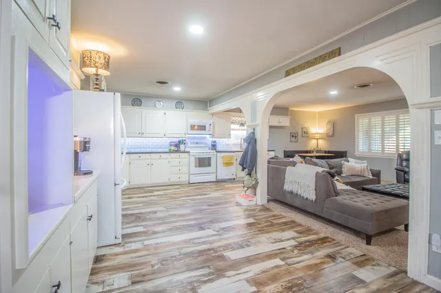 a room with furniture and a kitchen view