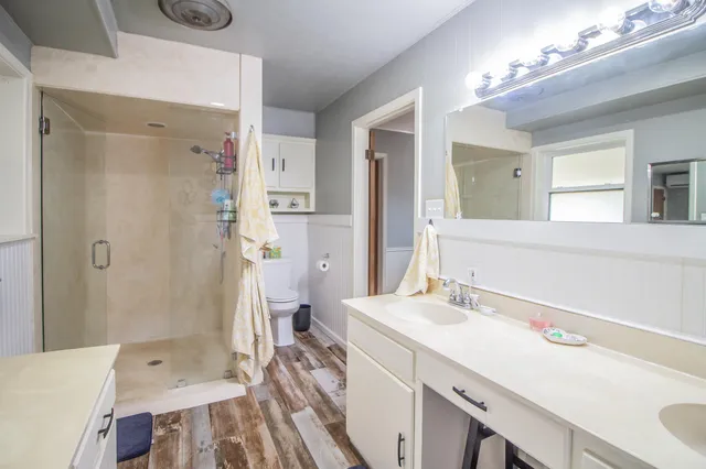 a bathroom with a sink toilet and a mirror