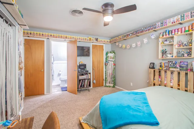 a bedroom with a bed and a chair