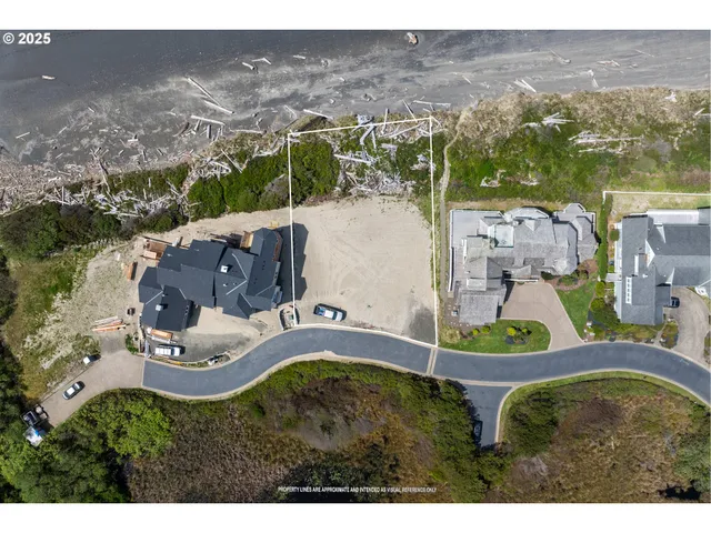 an aerial view of residential house with outdoor space and ocean view