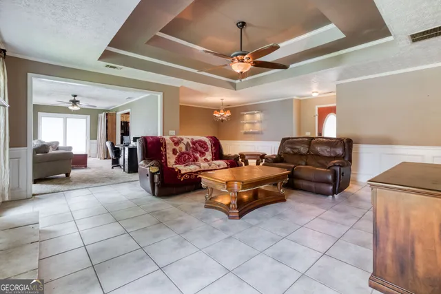 a living room with furniture and a chandelier