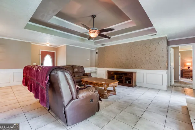 a living room with furniture a fireplace and a chandelier