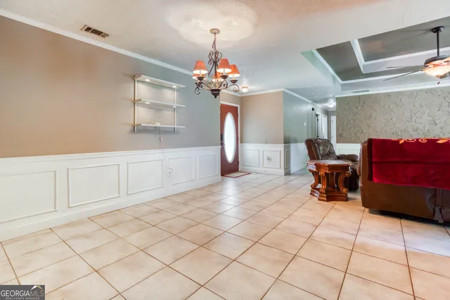 a living room with furniture and a chandelier