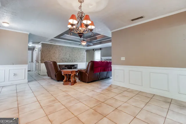 a living room with furniture and a chandelier