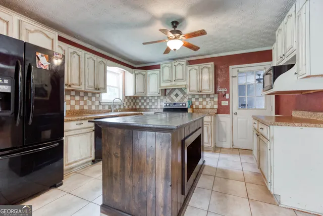 a kitchen with a sink stove and refrigerator
