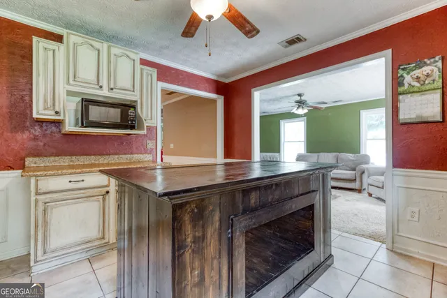 a kitchen with stainless steel appliances granite countertop a stove and cabinets