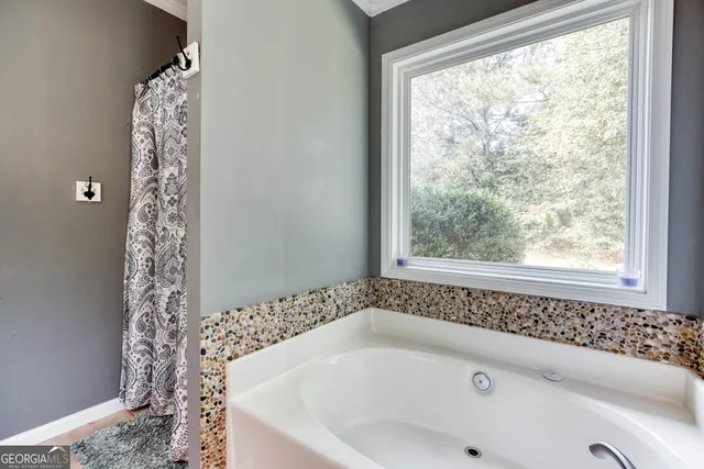 a bathroom with a bathtub and window