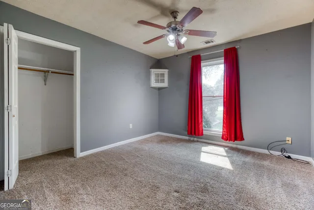 a view of a room with stainless steel appliances chandelier and a refrigerator