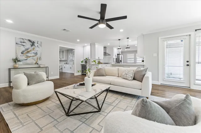 a living room with furniture and a view of kitchen