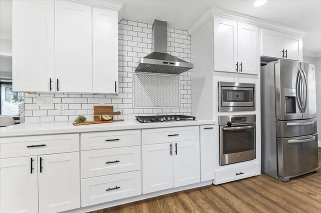 a kitchen with cabinets and stainless steel appliances