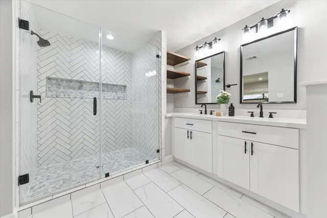 a bathroom with a shower sink and mirror