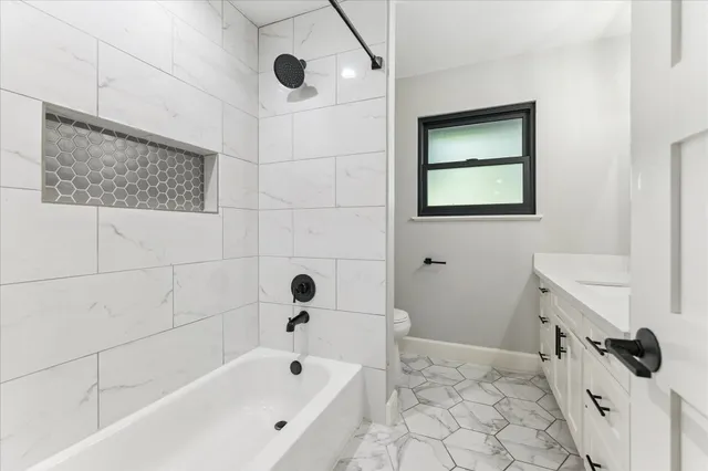 a bathroom with a bathtub and shower