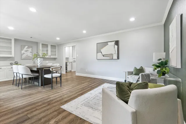 a living room with furniture wooden floor and a potted plant