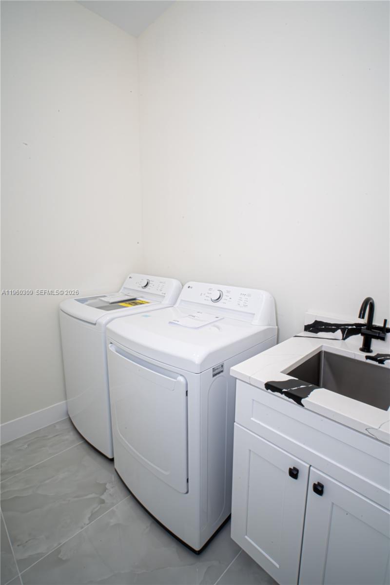 2903 East 17th Street Lehigh Acres, FL 33972 - Photo 18 of 34 a utility room with dryer and washer