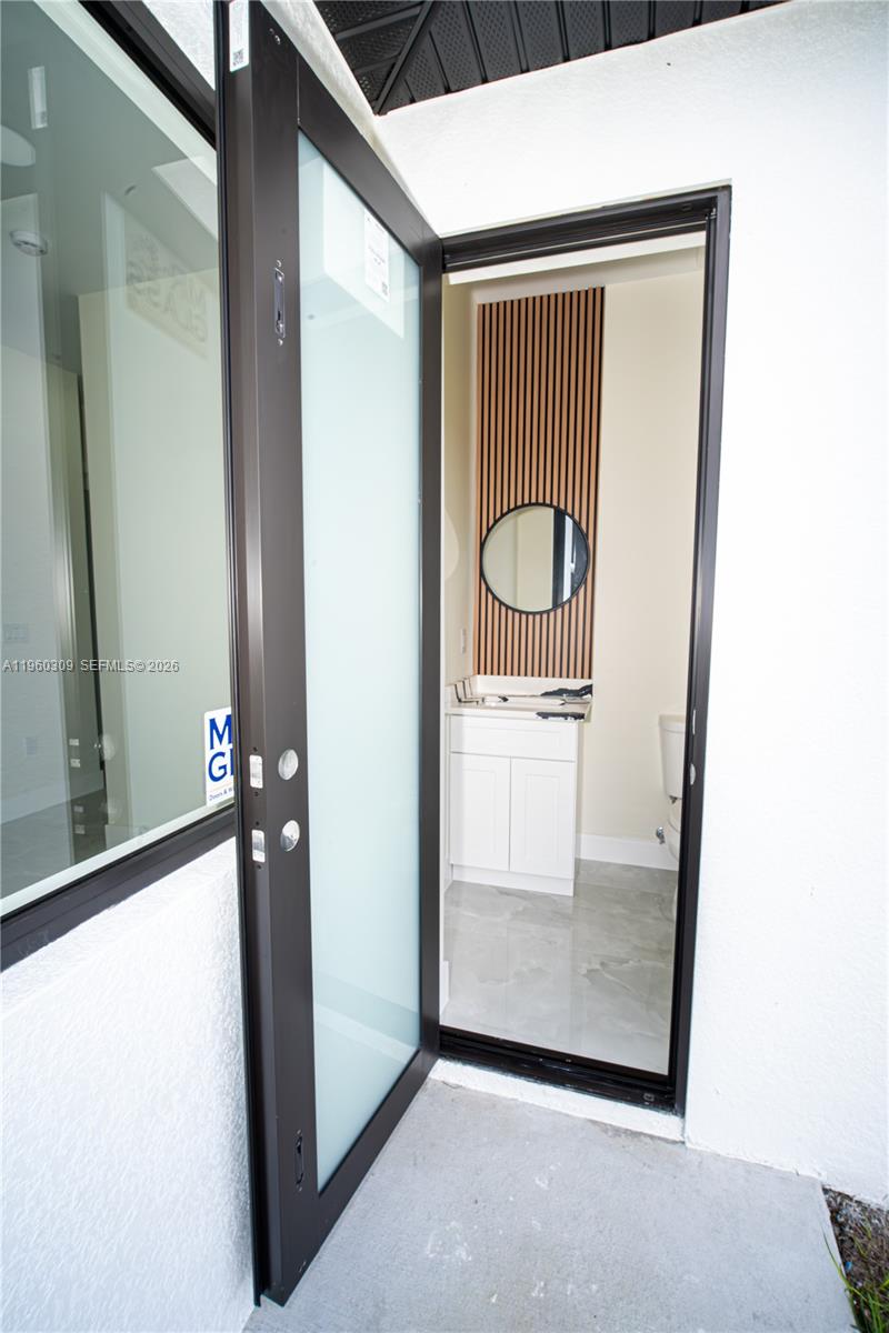 2903 East 17th Street Lehigh Acres, FL 33972 - Photo 19 of 34 a view of a hallway with a door