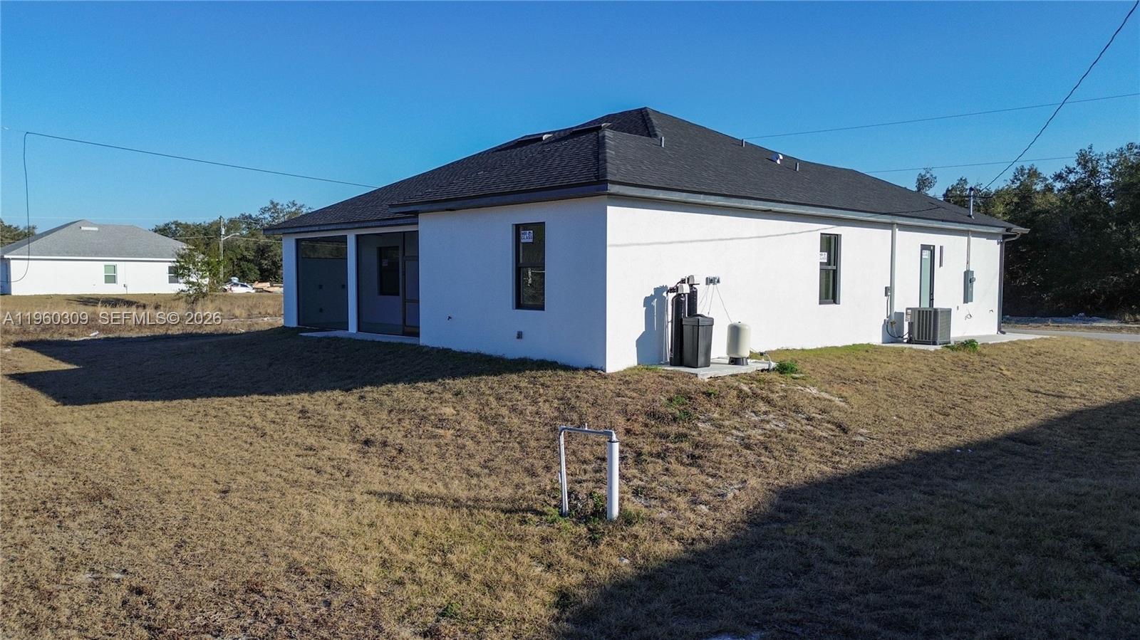 2903 East 17th Street Lehigh Acres, FL 33972 - Photo 20 of 34 a front view of a house with a yard