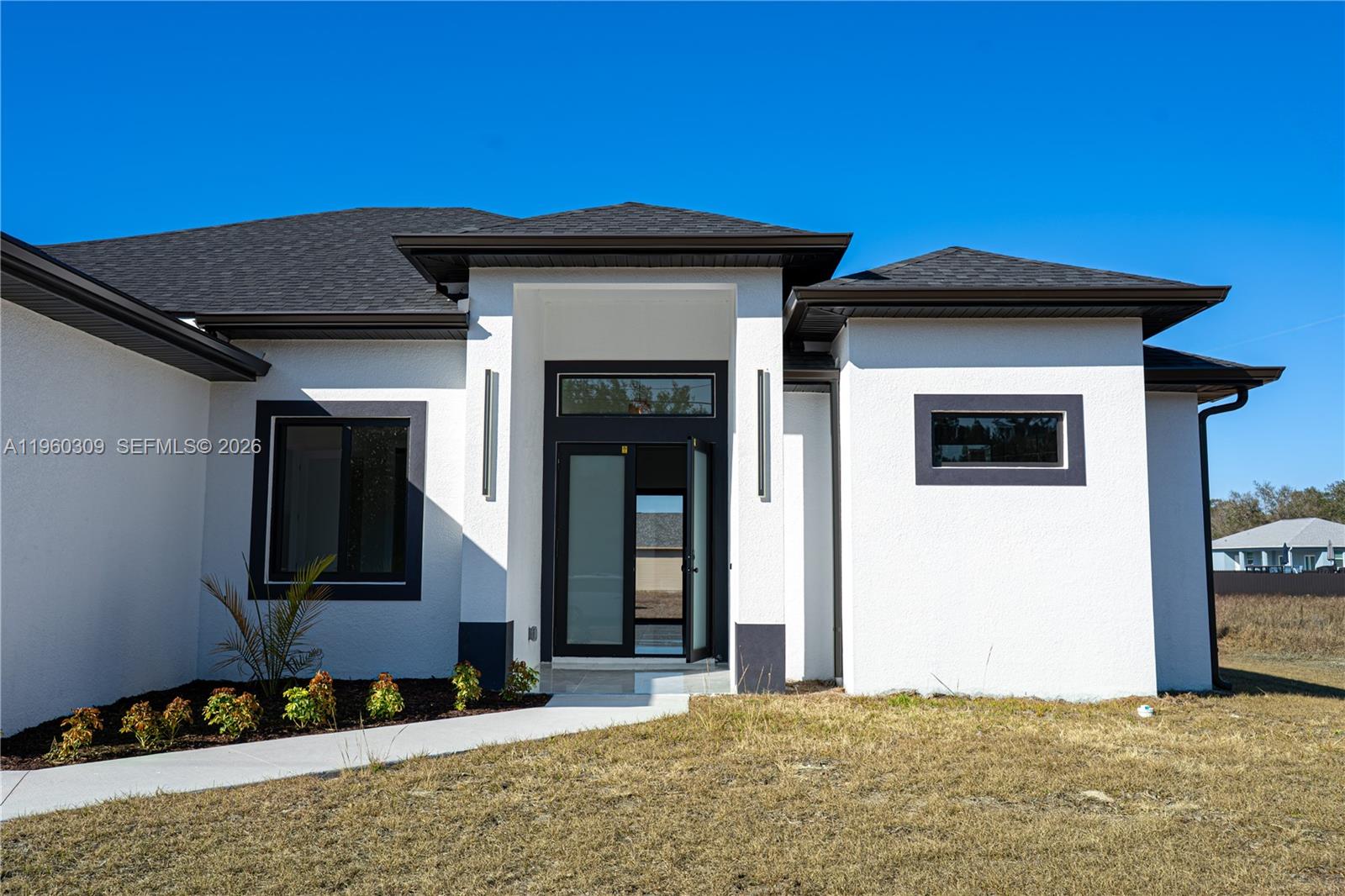 2903 East 17th Street Lehigh Acres, FL 33972 - Photo 2 of 34 a view of a house with a yard