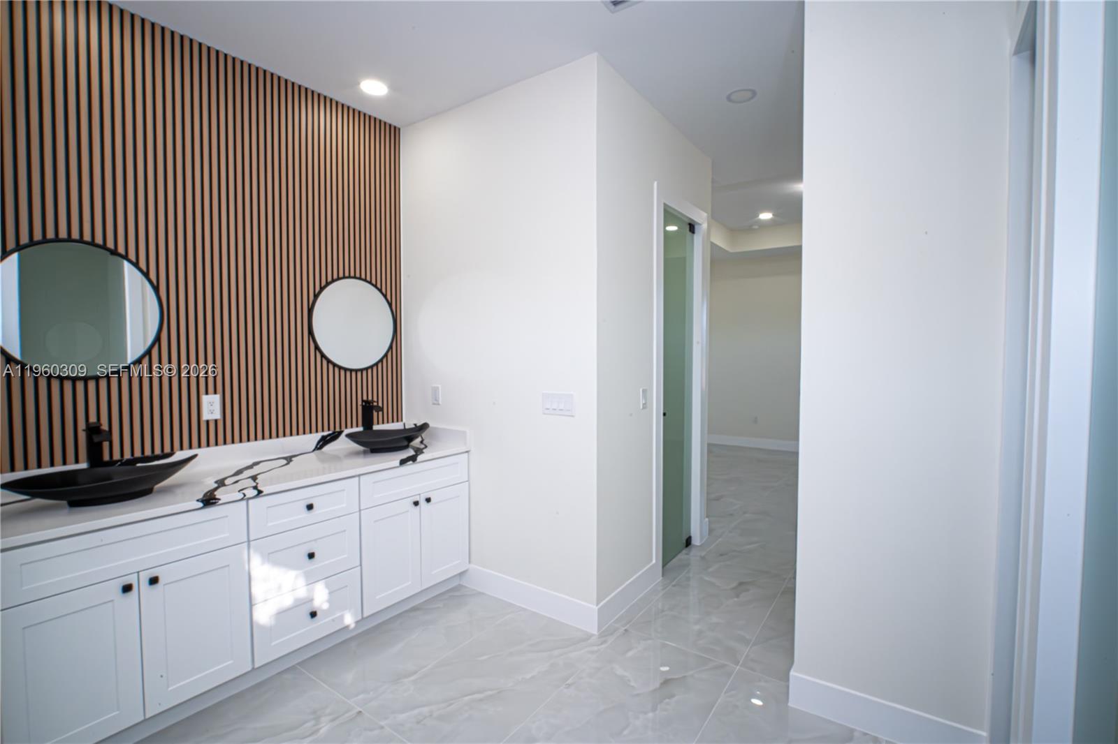 2903 East 17th Street Lehigh Acres, FL 33972 - Photo 22 of 34 a bathroom with a sink a toilet and a mirror