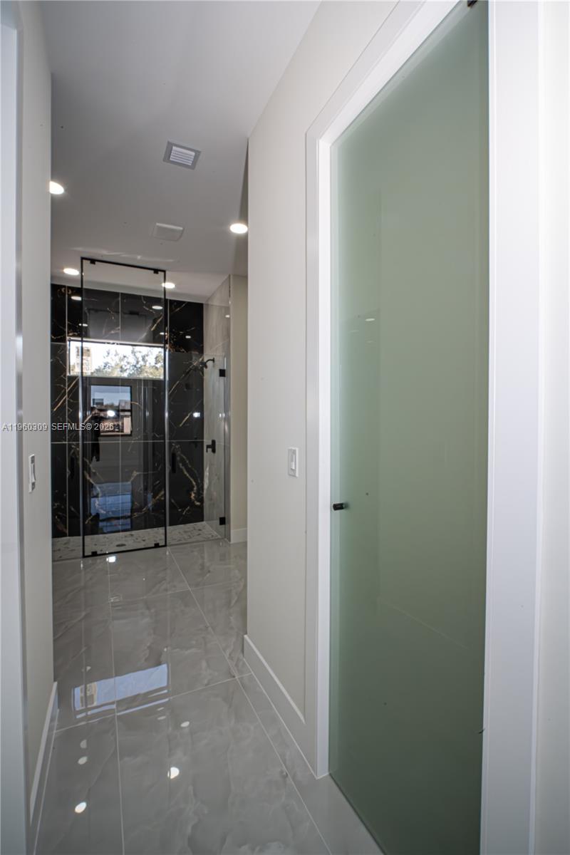 2903 East 17th Street Lehigh Acres, FL 33972 - Photo 25 of 34 a view of a hallway with wooden shelves
