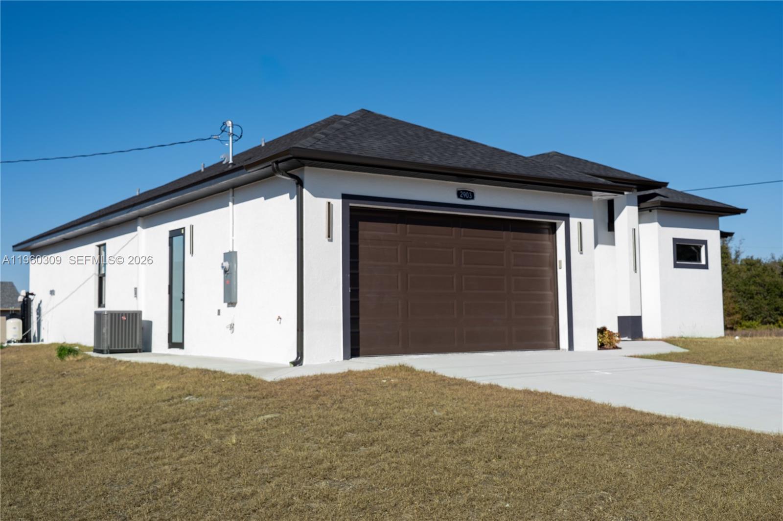 2903 East 17th Street Lehigh Acres, FL 33972 - Photo 4 of 34 a front view of a house with a garage