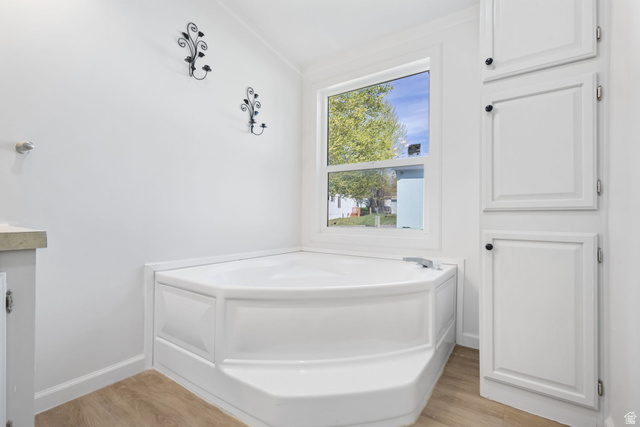 2600 North Hill Field Road, Unit 86 Layton, UT 84041 - Photo 13 of 25 Bathroom featuring a garden tub, light wood-style flooring, and vanity