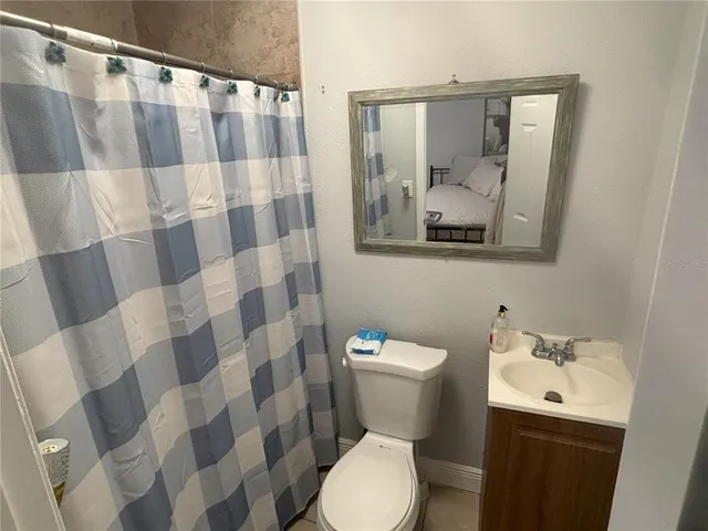 a white toilet sitting next to a bathroom sink