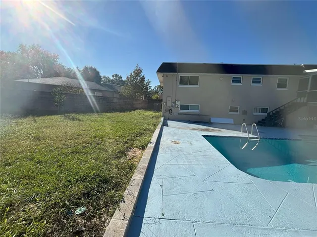 a view of a swimming pool with an outdoor seating