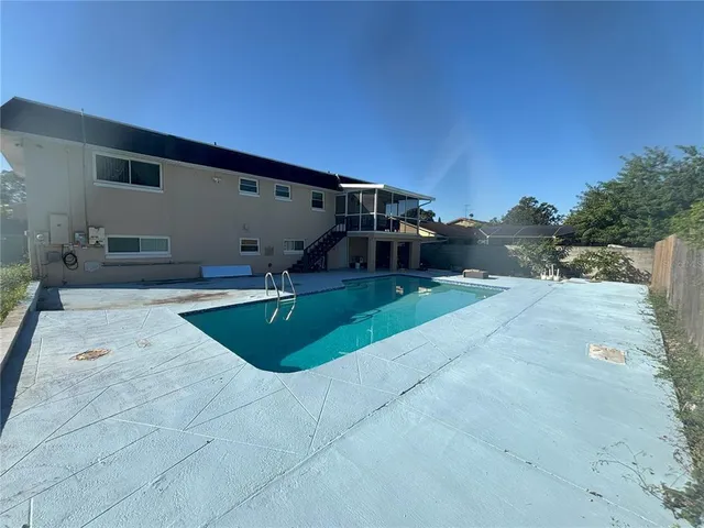a swimming pool with outdoor seating and yard
