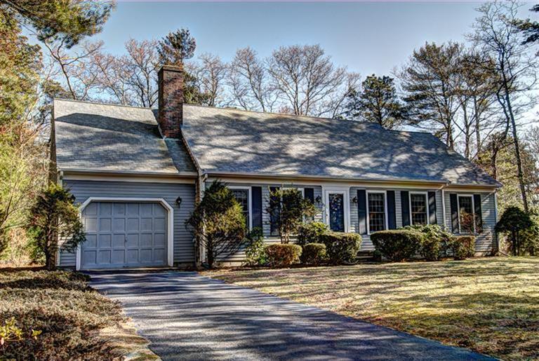 a view of a house with a tree in front