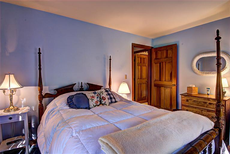 80 Sea Robin Road Osterville, MA 02655 - Photo 17 of 20 a bedroom with a bed and a chandelier