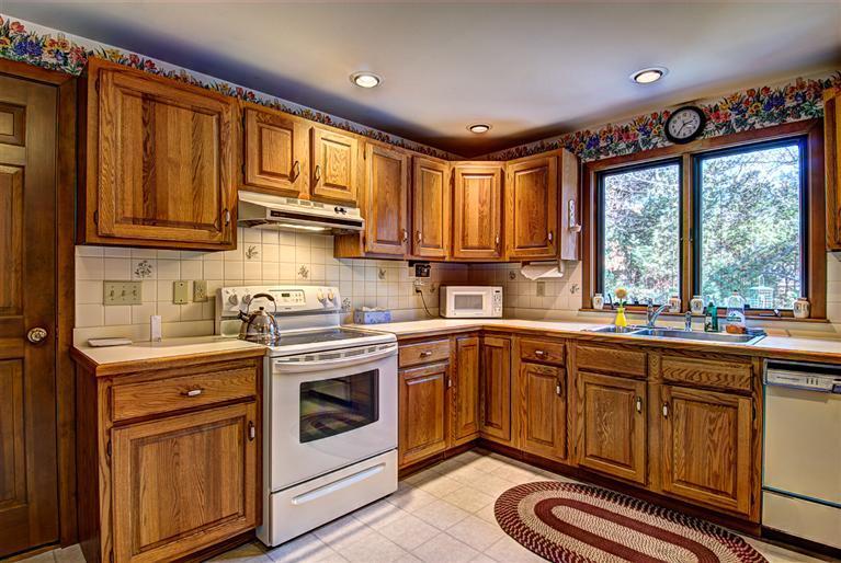 80 Sea Robin Road Osterville, MA 02655 - Photo 10 of 20 a kitchen with stainless steel appliances granite countertop a stove sink and cabinets
