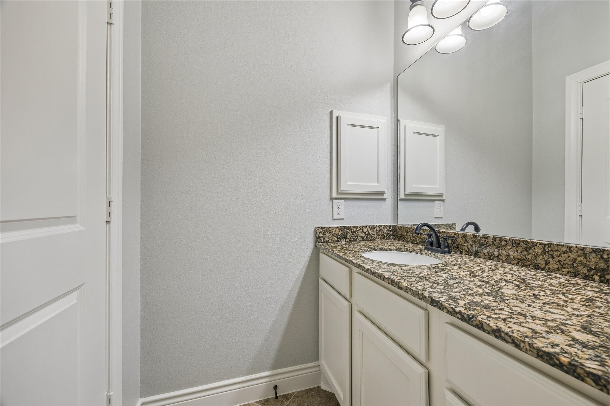 1616 Hewitt Drive Houston, TX 77018 - Photo 20 of 44 Secondary bathroom offers granite counters, ample storage cabinetry, and bright vanity lighting.