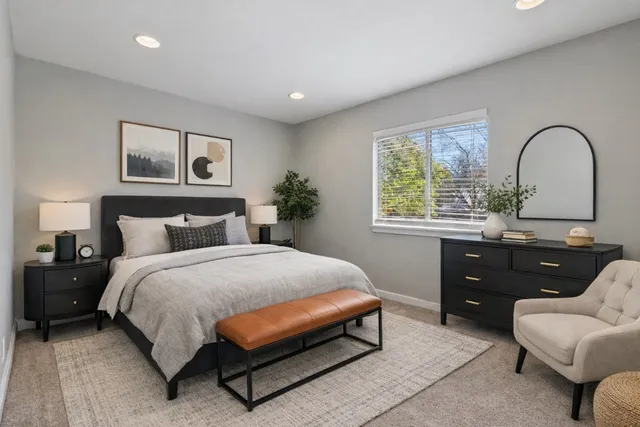 a spacious bedroom with a bed and a large window