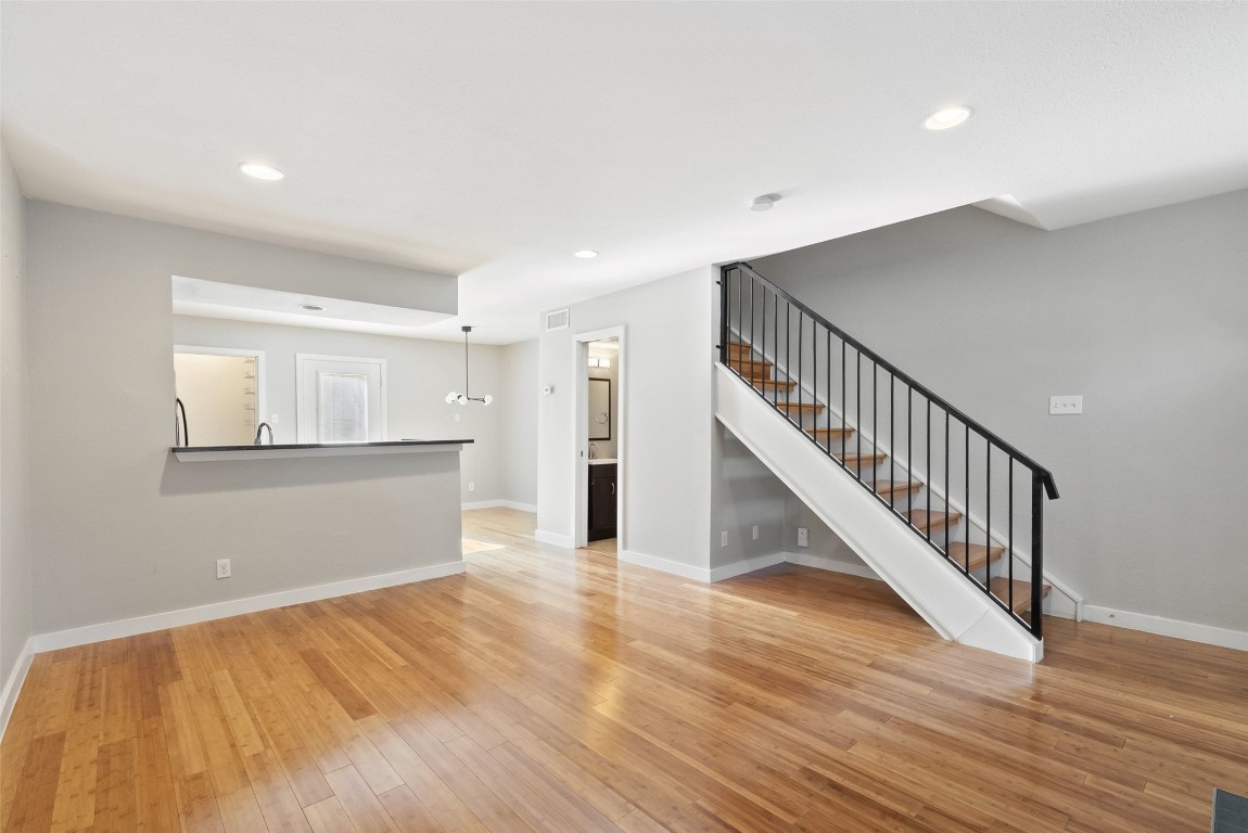 3601 Menchaca Road, Unit 117 Austin, TX 78704 - Photo 3 of 29 a view of an empty room with wooden floor and staircase