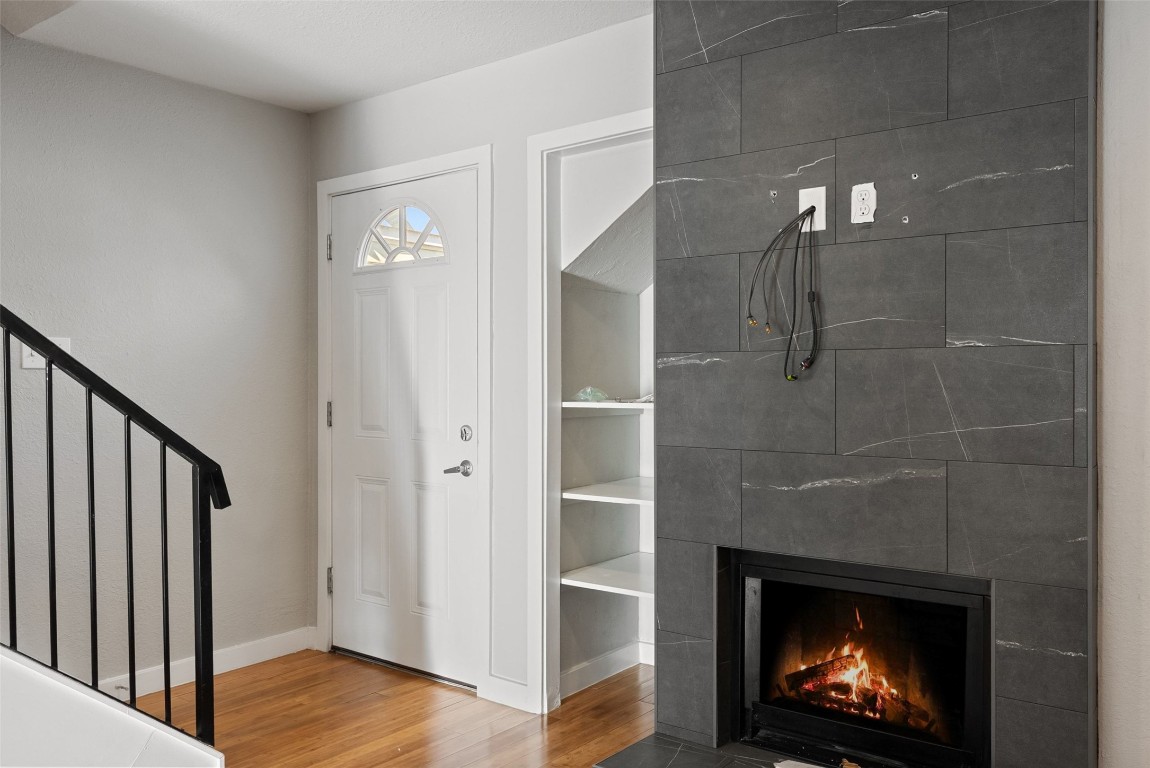 3601 Menchaca Road, Unit 117 Austin, TX 78704 - Photo 4 of 29 a view of a hallway with wooden floor and a fireplace