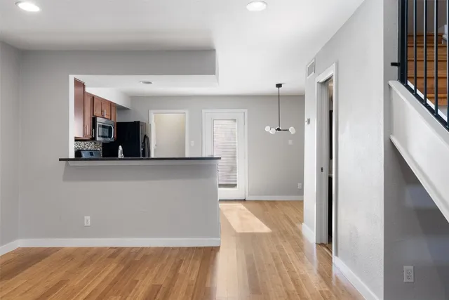 a view of a kitchen from a hallway