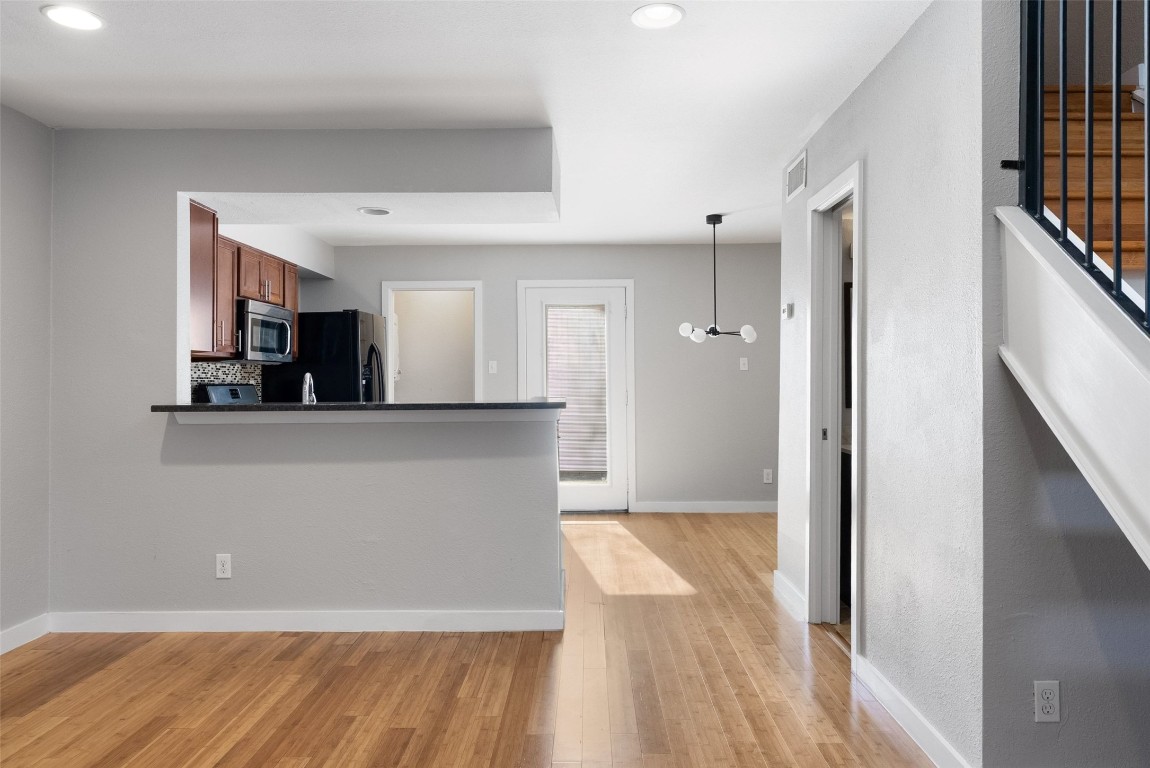 3601 Menchaca Road, Unit 117 Austin, TX 78704 - Photo 6 of 25 a view of a kitchen from a hallway