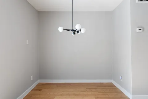 a view of a room with wooden floor