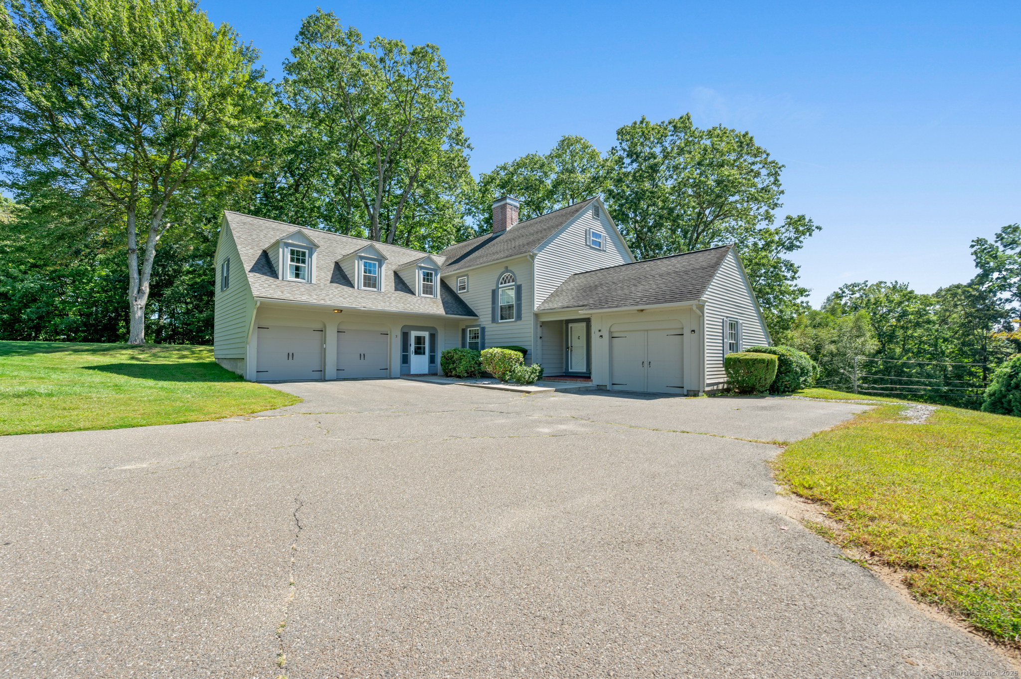 46 Edgewood Street, Unit 2 Stafford, CT 06076 - Photo 1 of 1 a front view of a house with a yard and garage