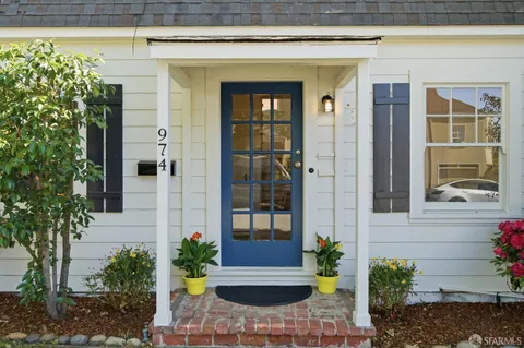 a view of front door of house with potted plant