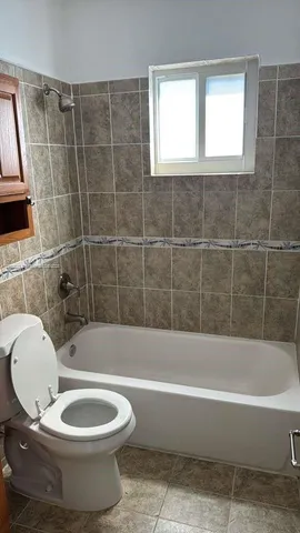 a bathroom with a toilet a sink and bathtub