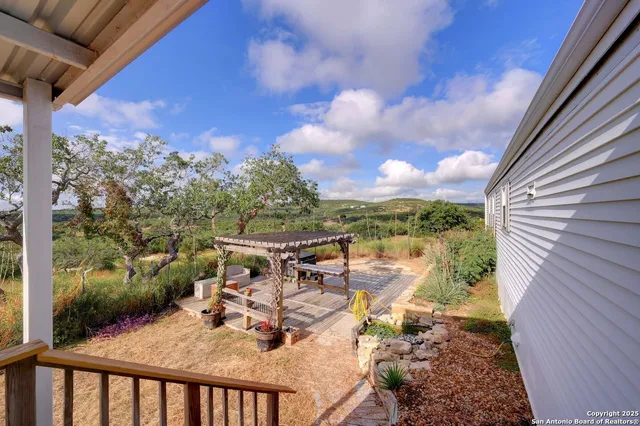 a view of a balcony with mountain view and wooden floor